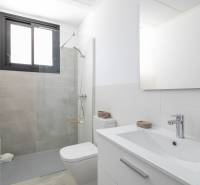 Bathroom in a villa with a modern shower cabin and white furniture.