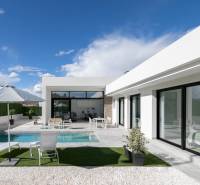 A villa in Calasparra with a swimming pool and garden seating under a sunshade.