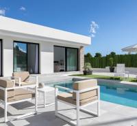 Villa in Calasparra with a pool and a relaxation area on the terrace under a parasol.