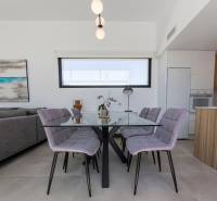 Dining table with a glass top and six chairs in the interior of the Villa.
