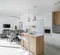 Spacious kitchen in the villa with an island, dining table, and modern appliances.
