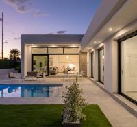 The exterior of the villa in Calasparra with a garden, pool, and terrace at sunset.