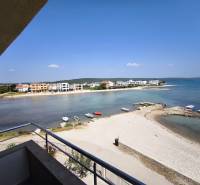 View from a studio apartment in Sukošan with a beach and coastline on the horizon.