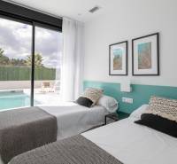 A bedroom in a villa with two beds, a view of the pool, and an outdoor terrace.