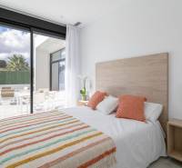 Bedroom in a villa with a view of the terrace, soft colors, wooden details.