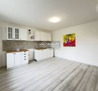 A clean space in a family house with white kitchen cabinets and a colorful painting.