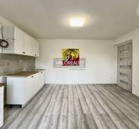 Interior of a family house with a kitchen unit and an abstract painting on the wall.