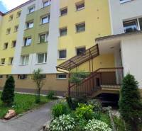 Apartment building on Tulska Street in Banska Bystrica with a colorful facade and flower bed.