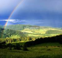 A rainbow over the green hills near the cottage in Dolná Lehota.