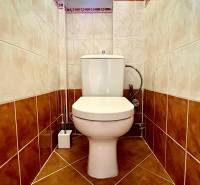 Separate toilet in a 2-room apartment with ceramic tiles and flooring.