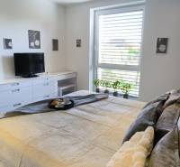 A bright bedroom with a bed and a television in a family house, decorations on the walls.