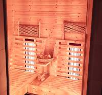 Interior of a family house with a wooden sauna and lighting, with seats for relaxation.