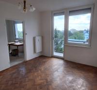 A bright room with parquet floors, a balcony, and an adjoining room in a 3-room apartment.