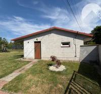 A family house in Trávnik with a single-story building and a well-maintained lawn in the garden.