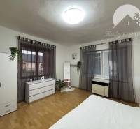 Bright room in a family house with wooden flooring and furniture.