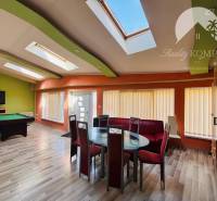 Interior of a family house with a seating area, pool table, and skylights.