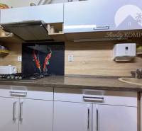 A kitchen in a family house with a gas stove and modern wall decorations.
