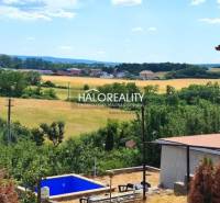 Gardens in Lučenec with a view of the landscape, a swimming pool, and nearby surrounding nature.