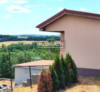 Gardens in Lučenec with a scenery of a rural environment and buildings in the distance.