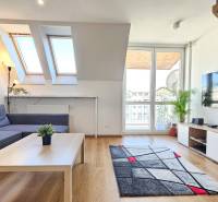 Bright living room with skylights and furniture in a 4-room apartment.