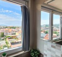 A view from the bathroom to the city, a 4-room apartment with a flower on the window.
