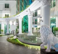 Apartment construction with impressive columns and a lion at the entrance.