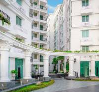 Apartment construction in Pattaya with elegant white buildings and Greek columns.