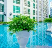 Exterior in Pattaya, apartment construction by the pool with floral decoration.
