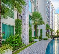 Apartment construction in Pattaya with a pool and greenery in an attractive environment.