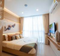 Bright bedroom with a large window and a double bed in a 3-room apartment.