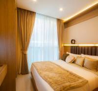A bedroom with a bed and a television in a 3-room apartment, interior with neutral colors.