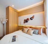 A bedroom in a 3-room apartment with a built-in wardrobe and decorative elements on the wall.