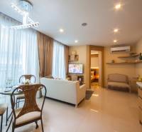 Living room in a 3-bedroom apartment with elegant furniture and a dining area.