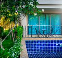 A garden with a swimming pool and seating area under construction in an apartment complex in Pattaya.