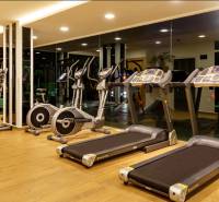 Gym with equipment under construction of apartments, treadmills and stationary bikes.