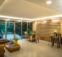 Interior of a living room with comfortable seating, decorations, and mailboxes, apartment construction.
