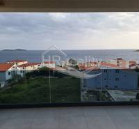 Sea view from the terrace of a holiday apartment in Zečevo, with nearby houses.