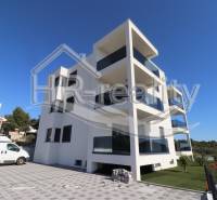 A recreational apartment in Zečevo with a sunny terrace and parking space in front of the building.