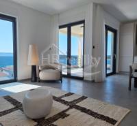 A bright interior of a holiday apartment with a sea view and comfortable seating.