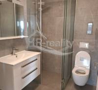 Bathroom in a holiday apartment with a modern shower and mirror.