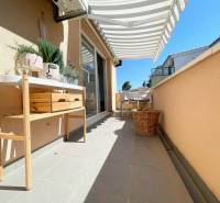 Terrace of a recreational apartment in Šolta with furniture, decorative plants, and a sun awning.