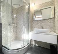 Bathroom in a holiday apartment with a modern shower and sink.