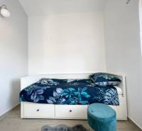Recreational apartment with a bed and blue patterned bedding.
