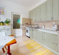 A bright kitchen with cabinets, a dining table, and decorations in a 4-room apartment.