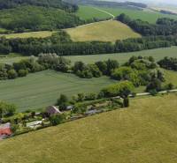 Family houses near Podbranč surrounded by fields, forests, and vast countryside.