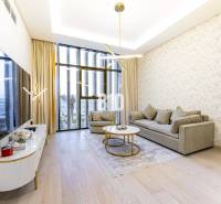 Living room in a 3-room apartment with large windows, a sofa, and a television on a wooden floor.