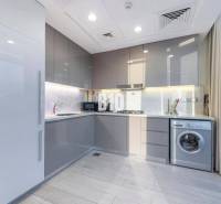 A kitchen in a 3-room apartment with modern appliances and large glass doors.