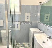 Bathroom in a 3-room apartment with a shower, washing machine, and sink.