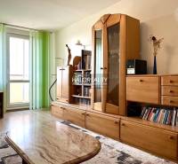 Living room with a wooden wall unit and light in a 3-room apartment.