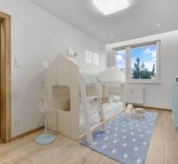 A children's room in a 4-room apartment with a bunk bed and a blue carpet with stars.